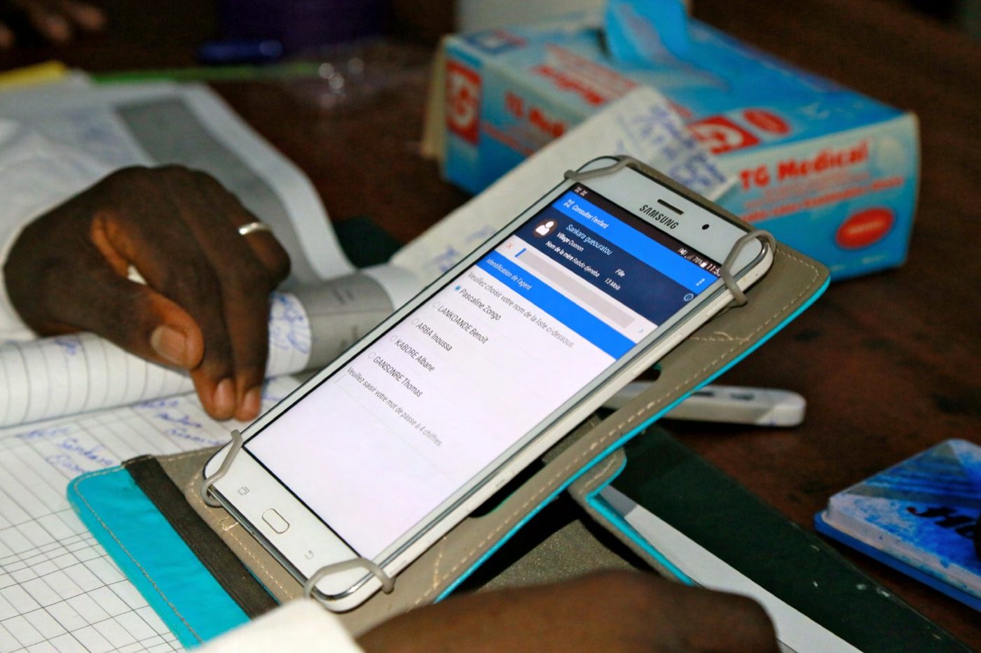 A frontline worker using a CommCare job aid on a mobile phone