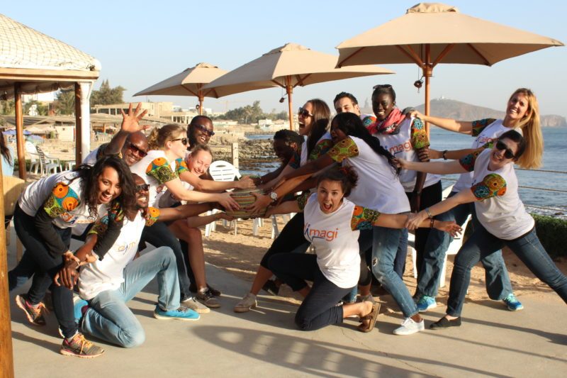 The Dimagi Global Services team posing playfully by the seaside