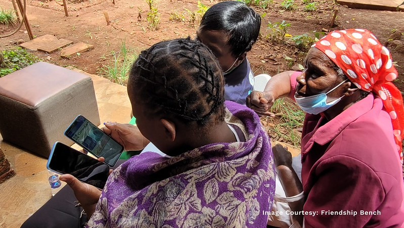 Community health workers use mobile case management software during a client visit in Zimbabwe